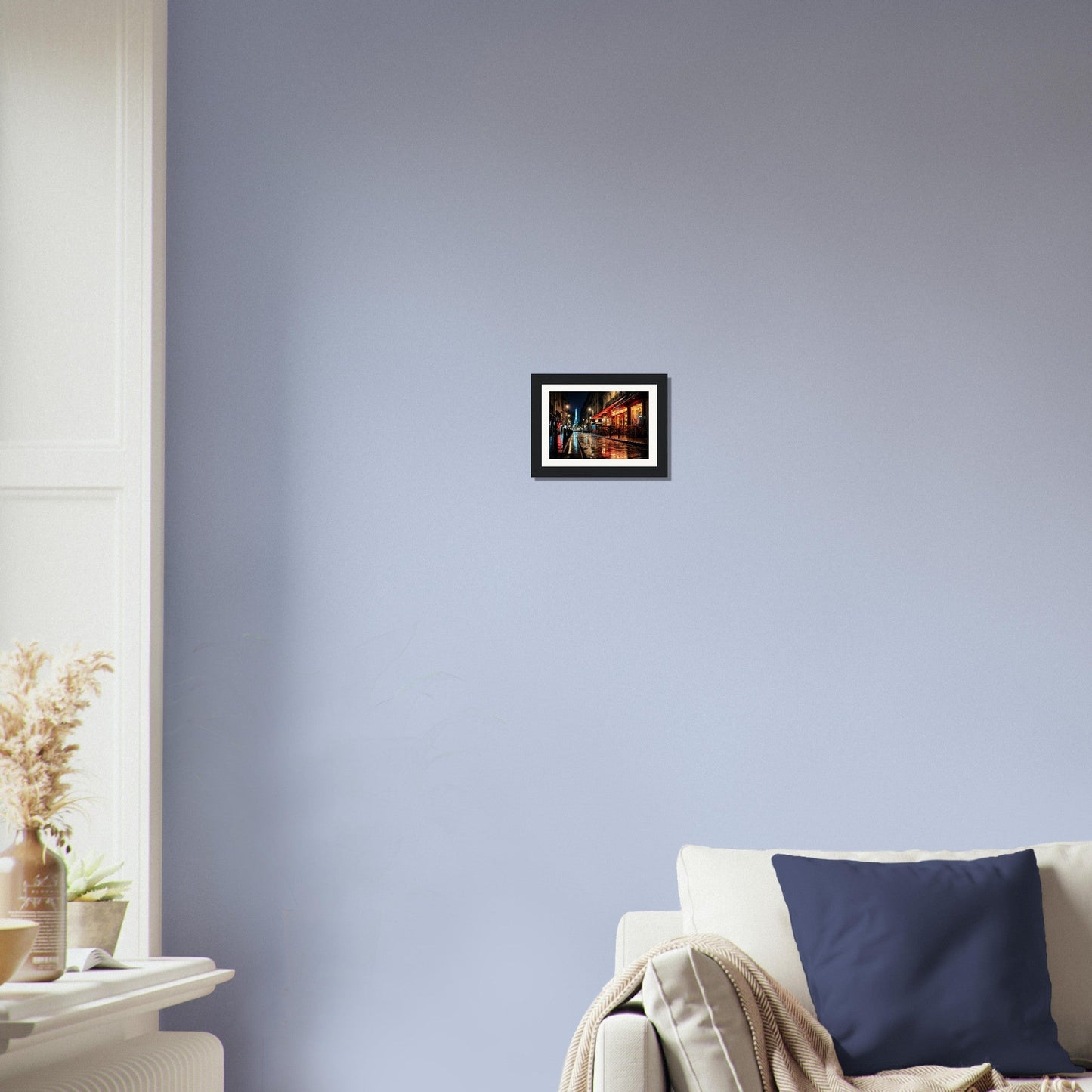 Framed artwork hanging on a pale blue wall.