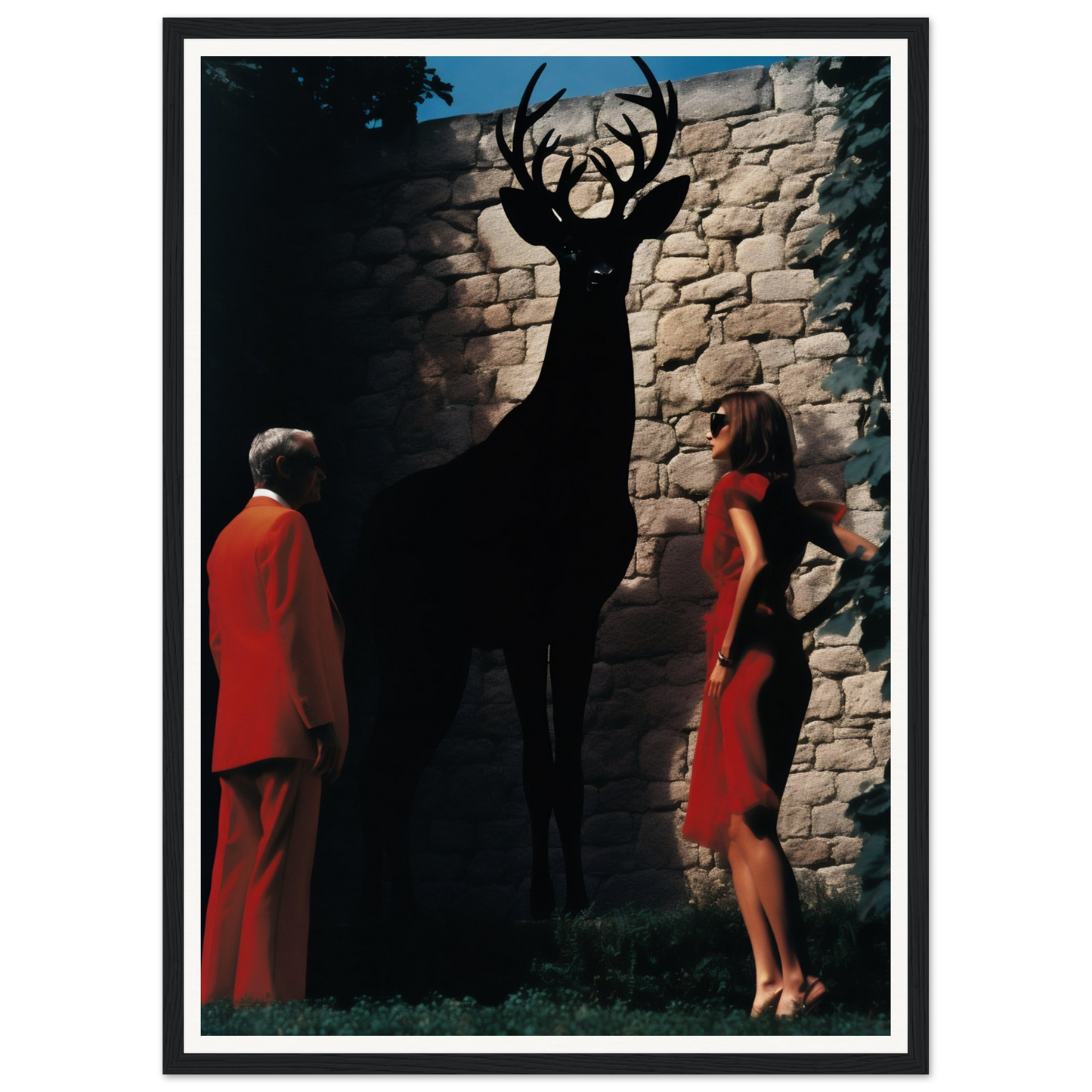 Silhouette of a deer with large antlers cast on a stone wall.