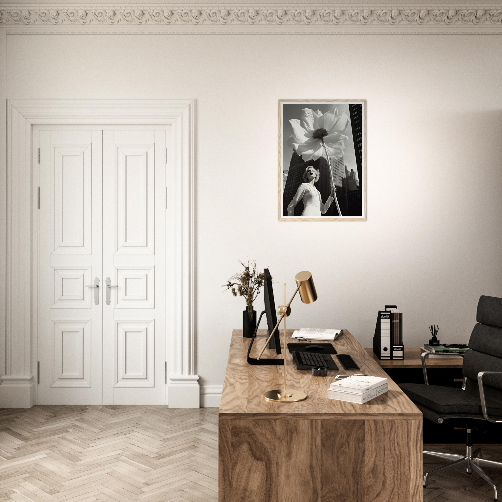 A desk with a chair and a framed photo on the wall