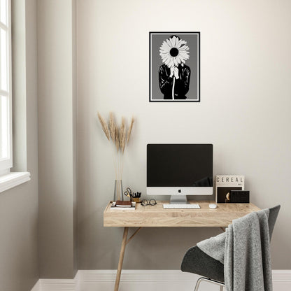 A desk with a computer and a flower