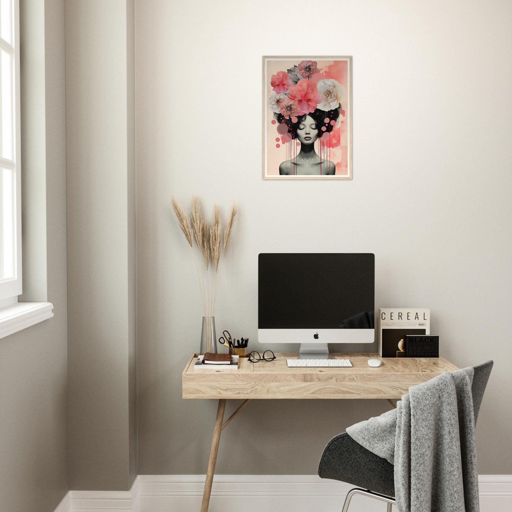 A desk with a computer and a pink flower