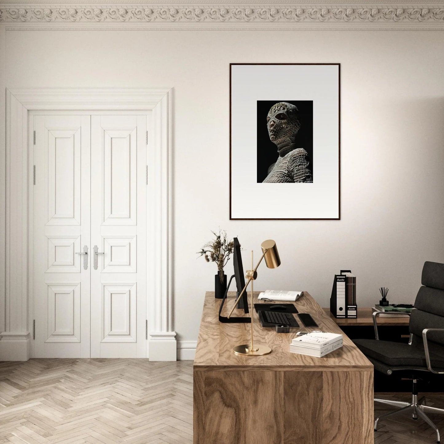 Elegant home office workspace with a wooden desk and framed portrait on the wall.