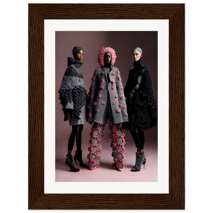 Framed photograph of three figures wearing elaborate, textured coats and headwear in muted and floral designs.