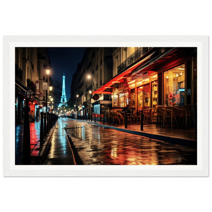 Illuminated Eiffel Tower visible at night from a Parisian street lined with cafes and shops.