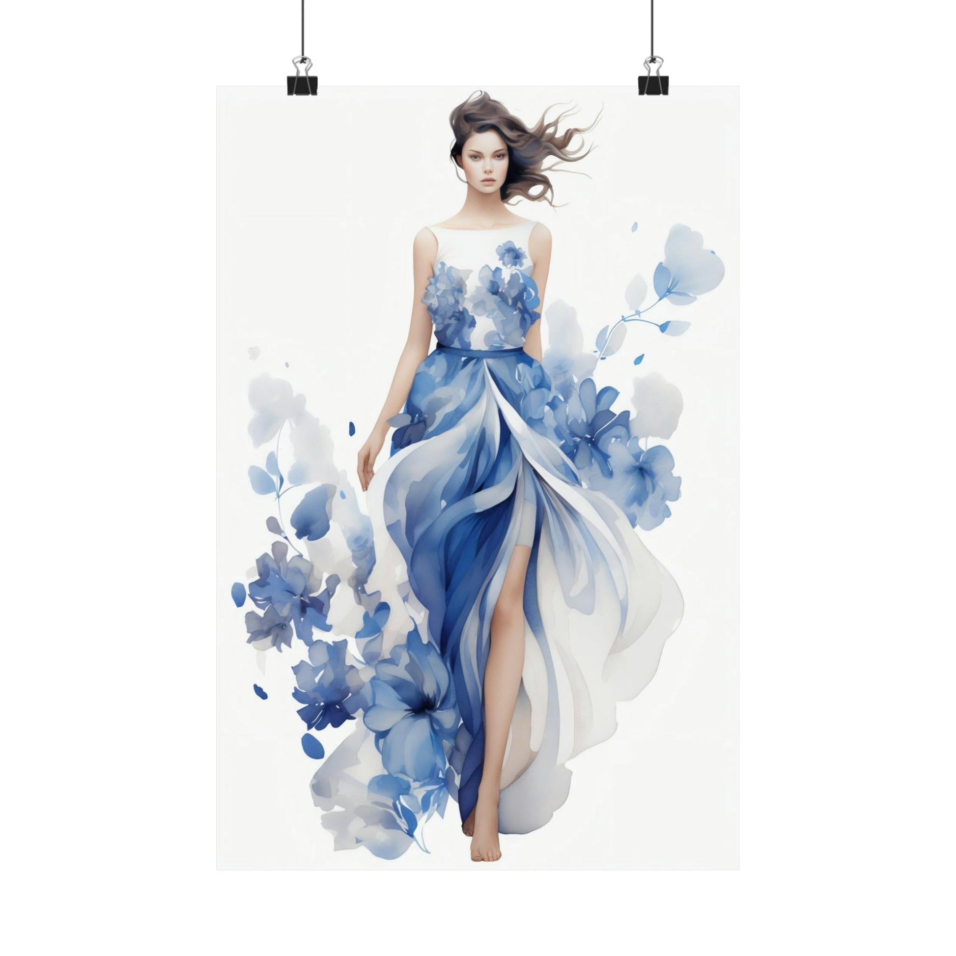 Woman wearing a flowing blue and white floral gown with her hair blowing in the wind.