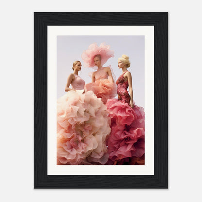 Framed artwork depicting three elegant women in voluminous, floral-inspired gowns of pink and peach hues.