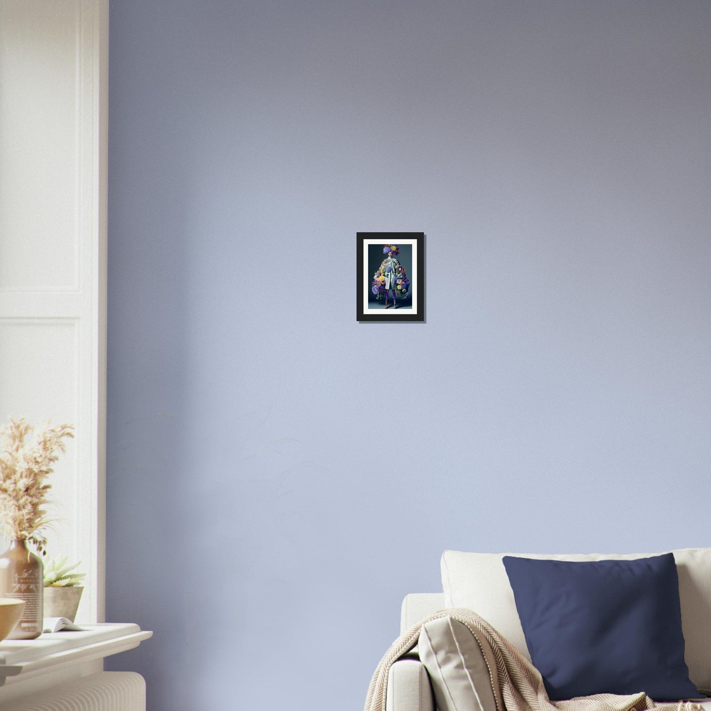 Framed artwork of a giraffe hanging on a pale blue wall.