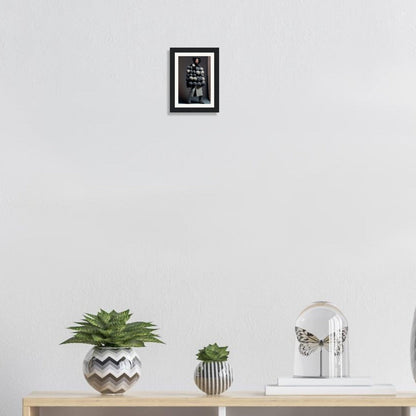 Wooden shelf or console table displaying potted plants, books, and a framed picture on the wall above.