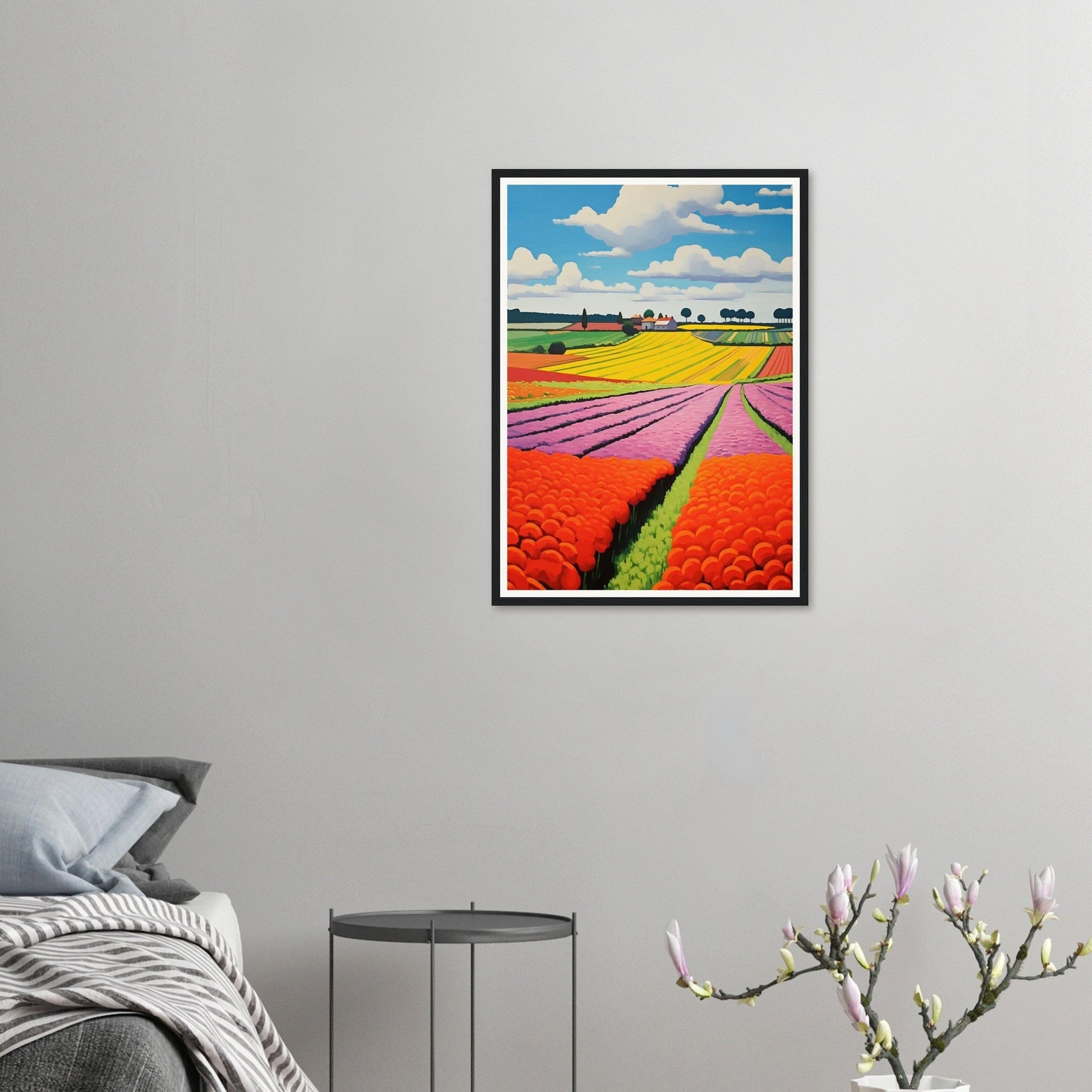 Framed photograph of colorful tulip fields stretching to the horizon under a blue sky with clouds.