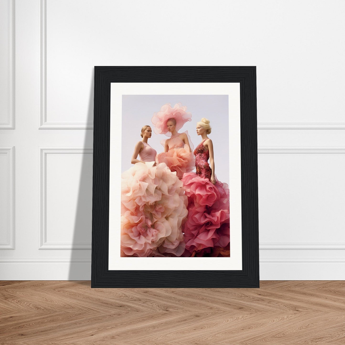 Framed artwork depicting three figures in voluminous, flowing gowns of pink and red hues.