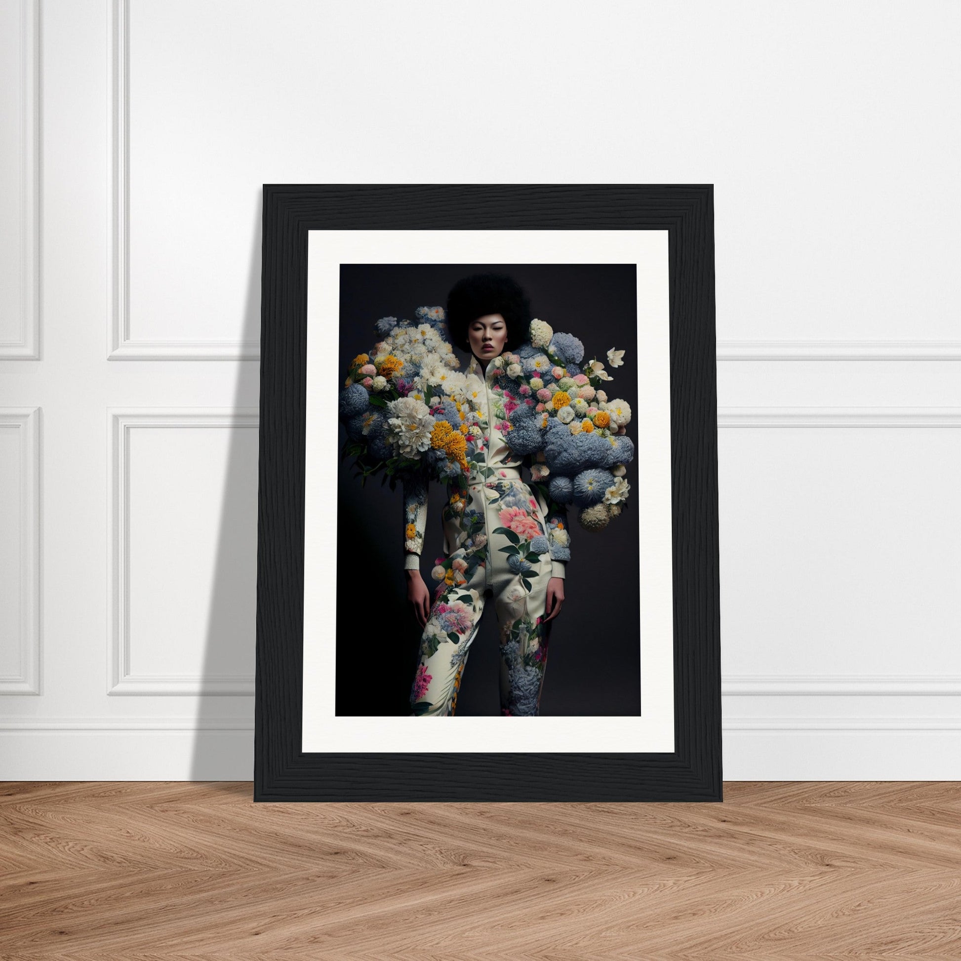 Framed artwork depicting a figure composed of colorful floral elements against a dark background.