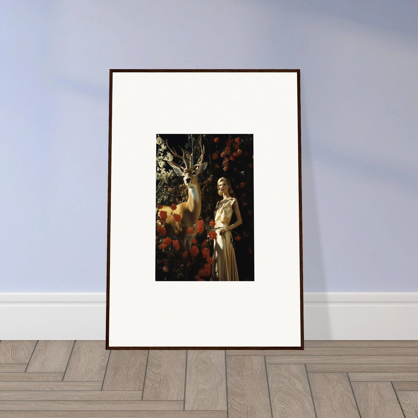 Framed artwork depicting a classical painting of a woman in a white dress standing near a tree.