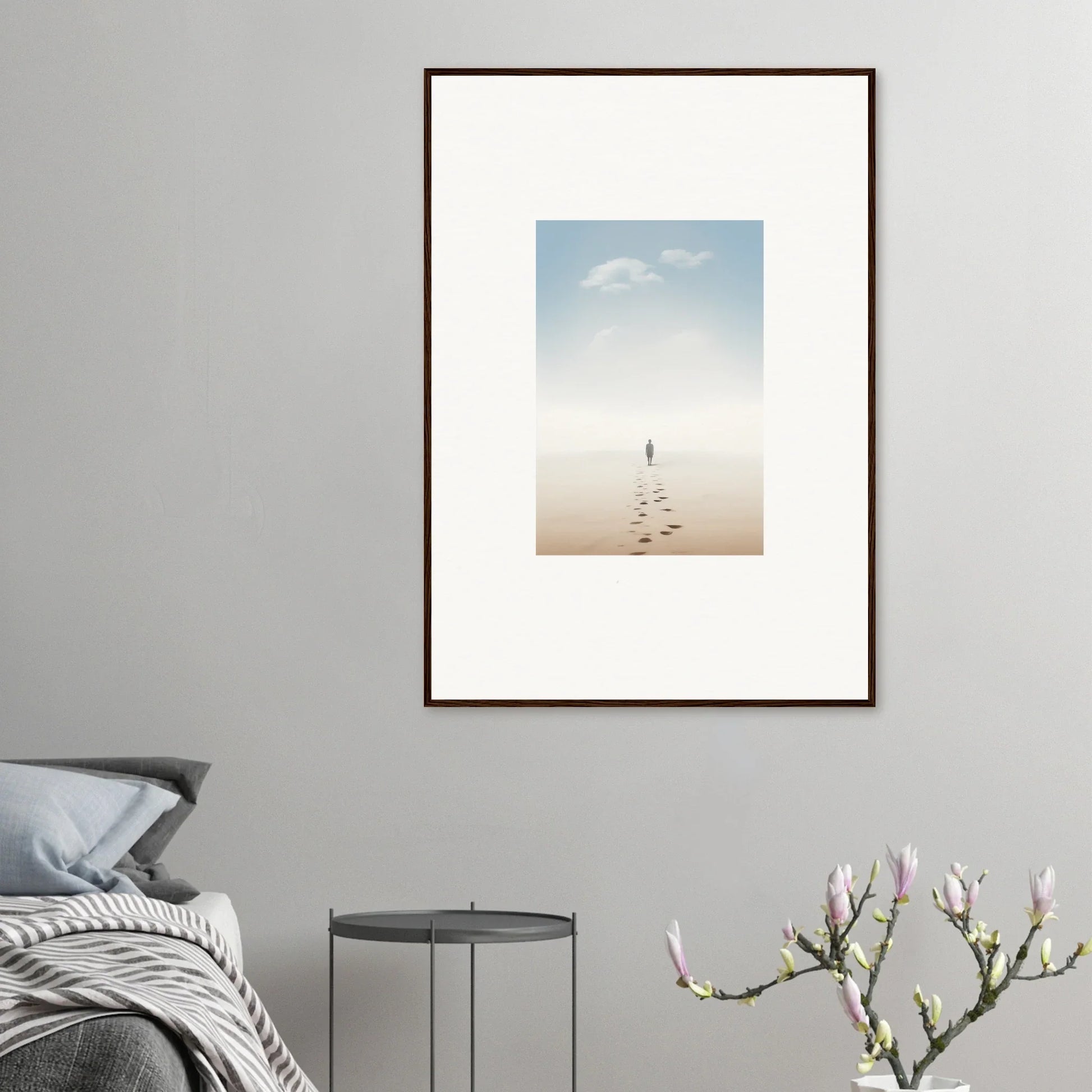 Framed wall art of a figure and footprints on a beach, embodying entwined nostalgia