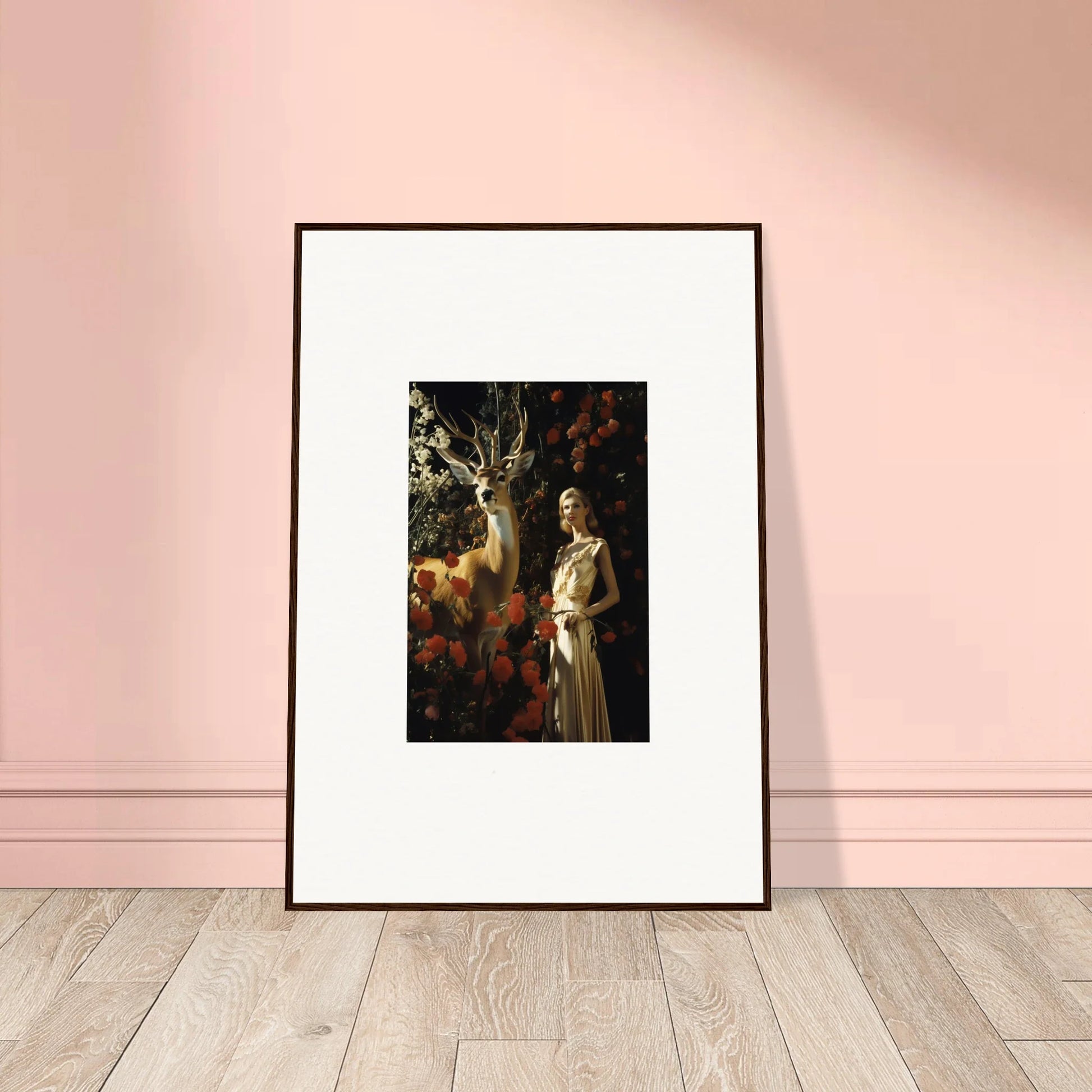 Framed artwork depicting a figure and a deer in a forest setting.