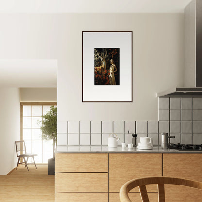 Framed artwork depicting a figure in a forest setting, hanging on a kitchen wall.