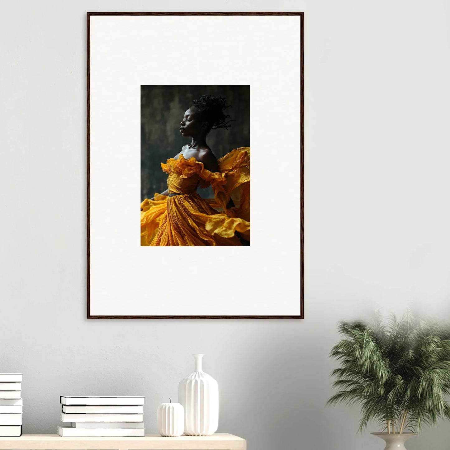 Framed wall art of figure in yellow-orange dress, perfect for sunlit whispers room decor