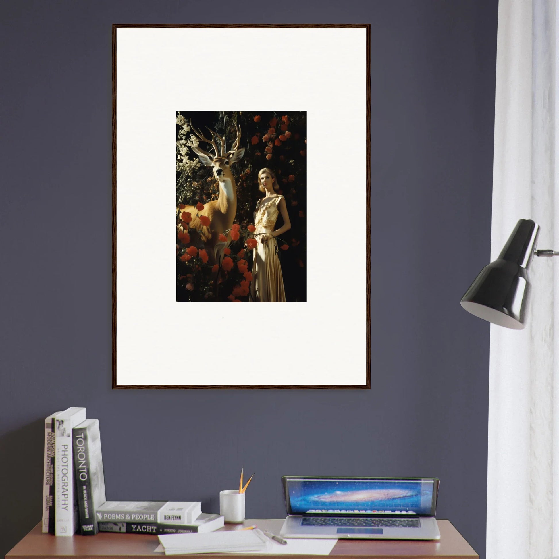 Framed artwork depicting a woman in a white dress standing next to a deer in a forest setting.