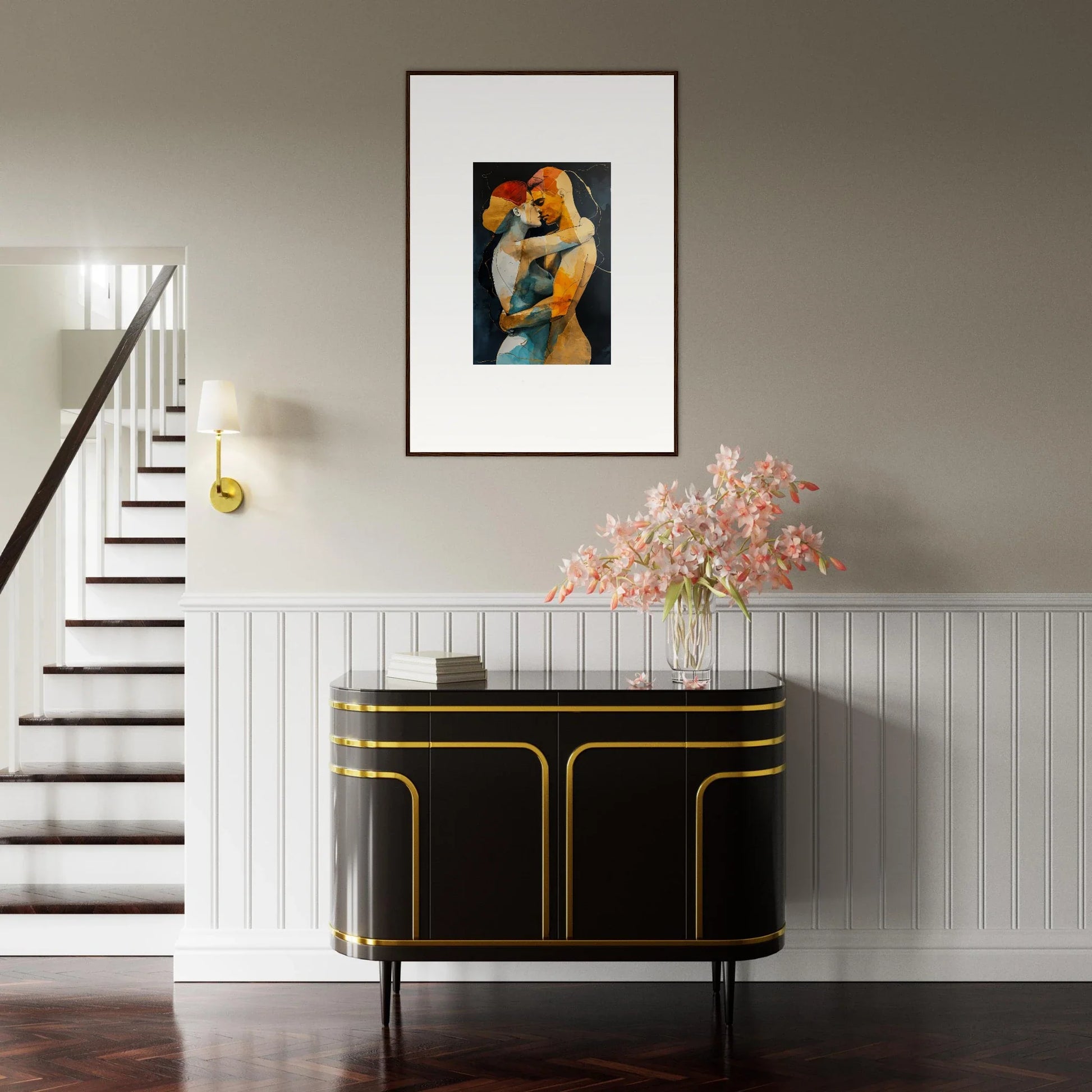 Framed wall art of an embracing couple above a chic black and gold sideboard for room decor