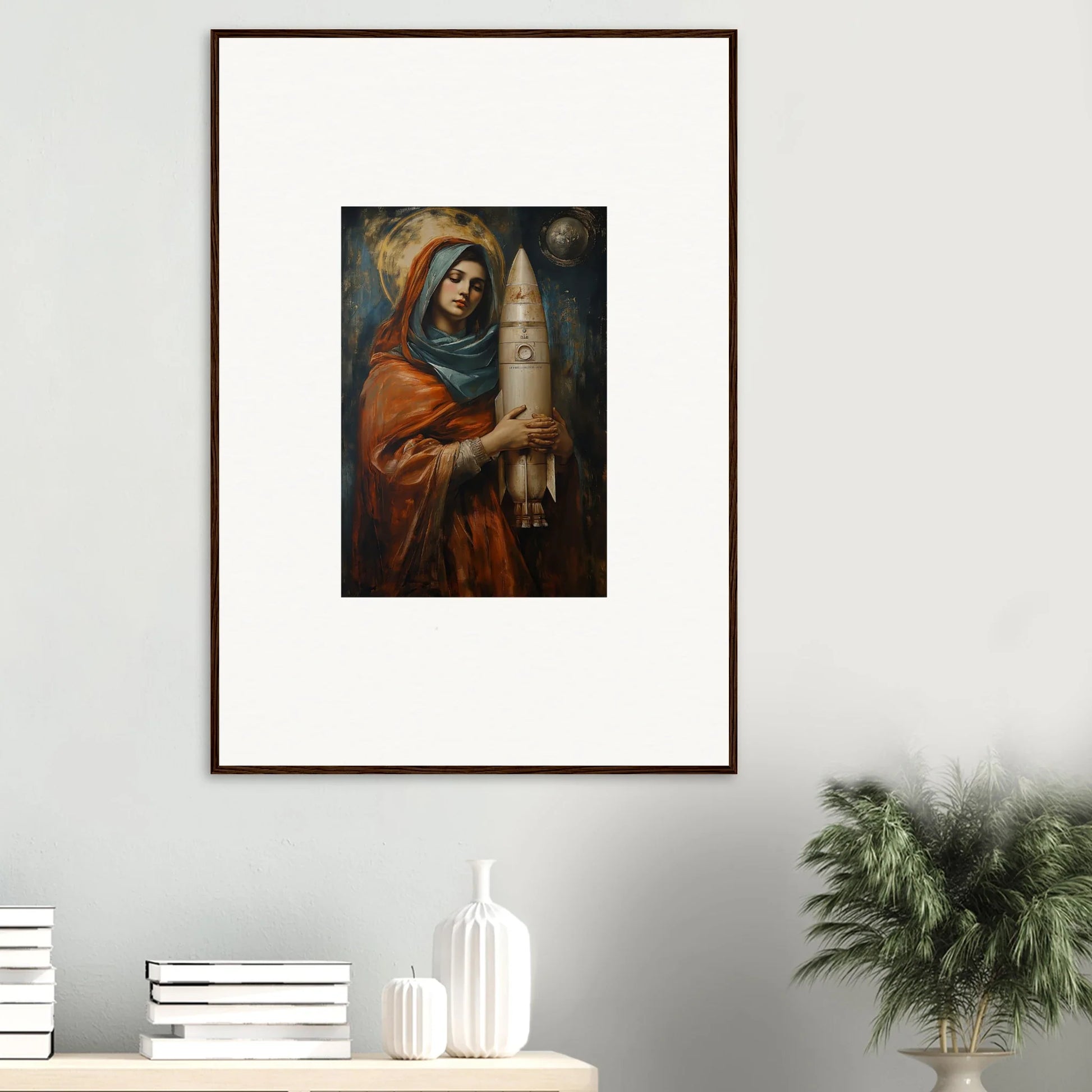 Framed wall art of figure in orange robes holding a tall candle for Quantum Atelier room decor