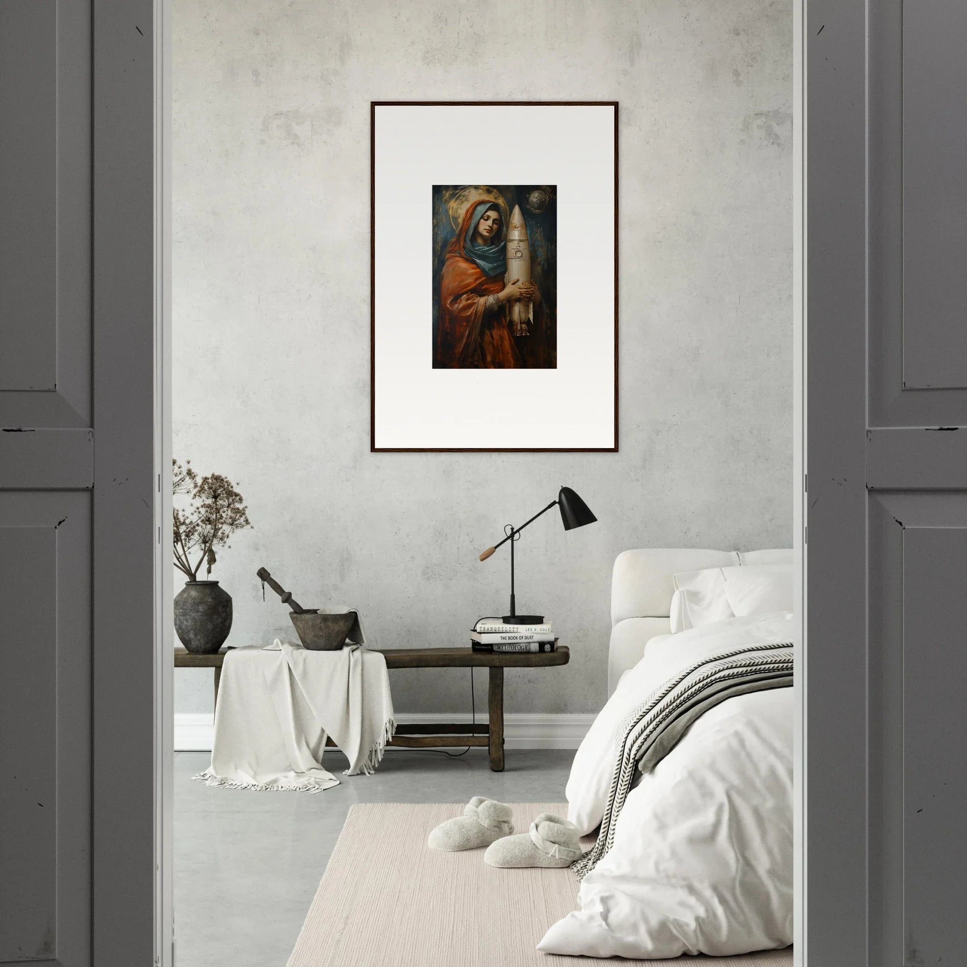 Framed wall art of a religious figure with a candle for Quantum Atelier room decor