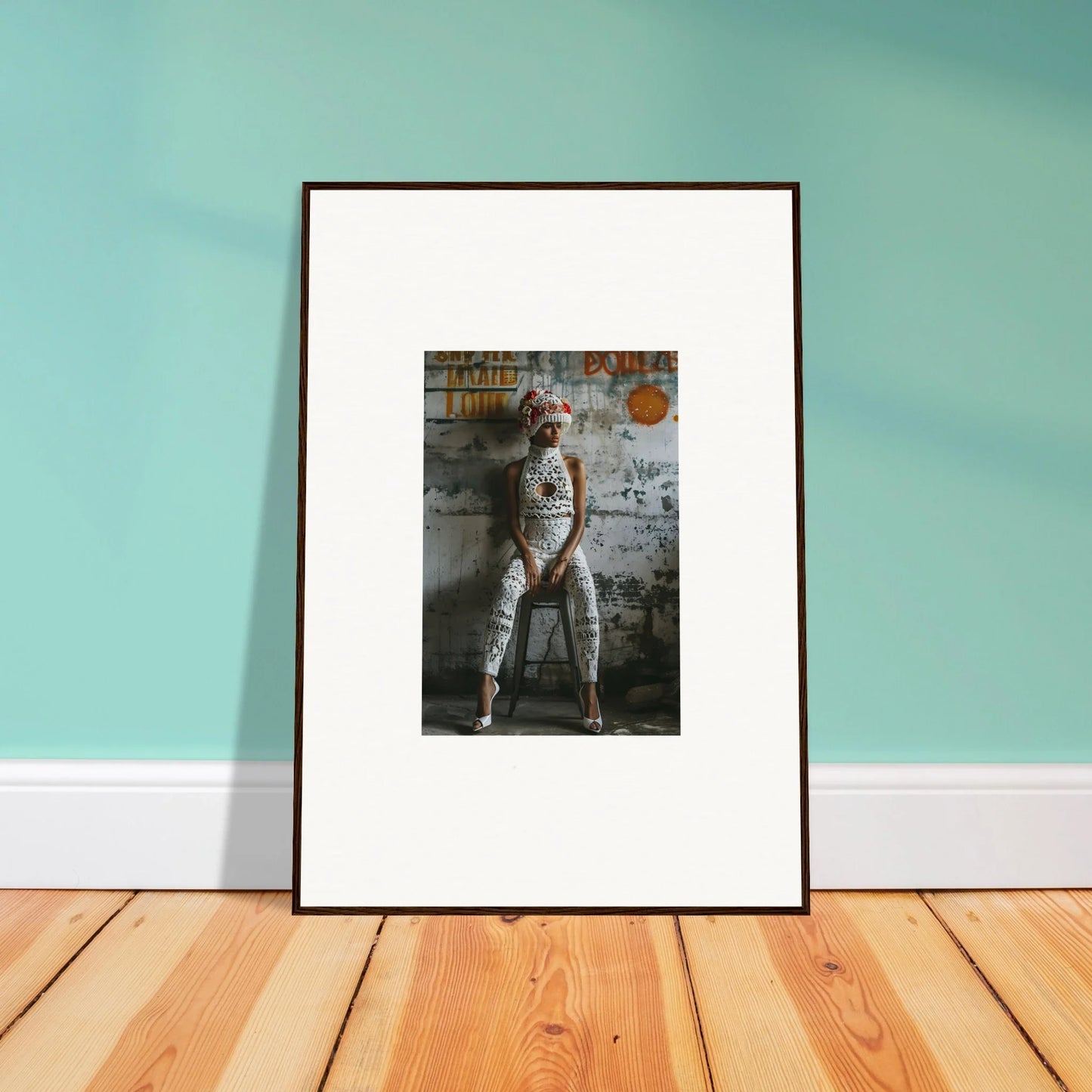 Framed wall art of a person in white outfit against graffitied wall for Geometry Whisper decor