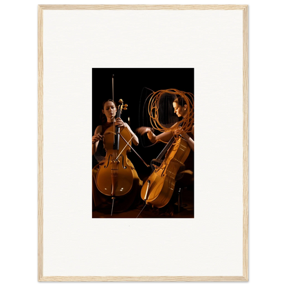 Framed wall art featuring two cellists performing with dramatic lighting effects