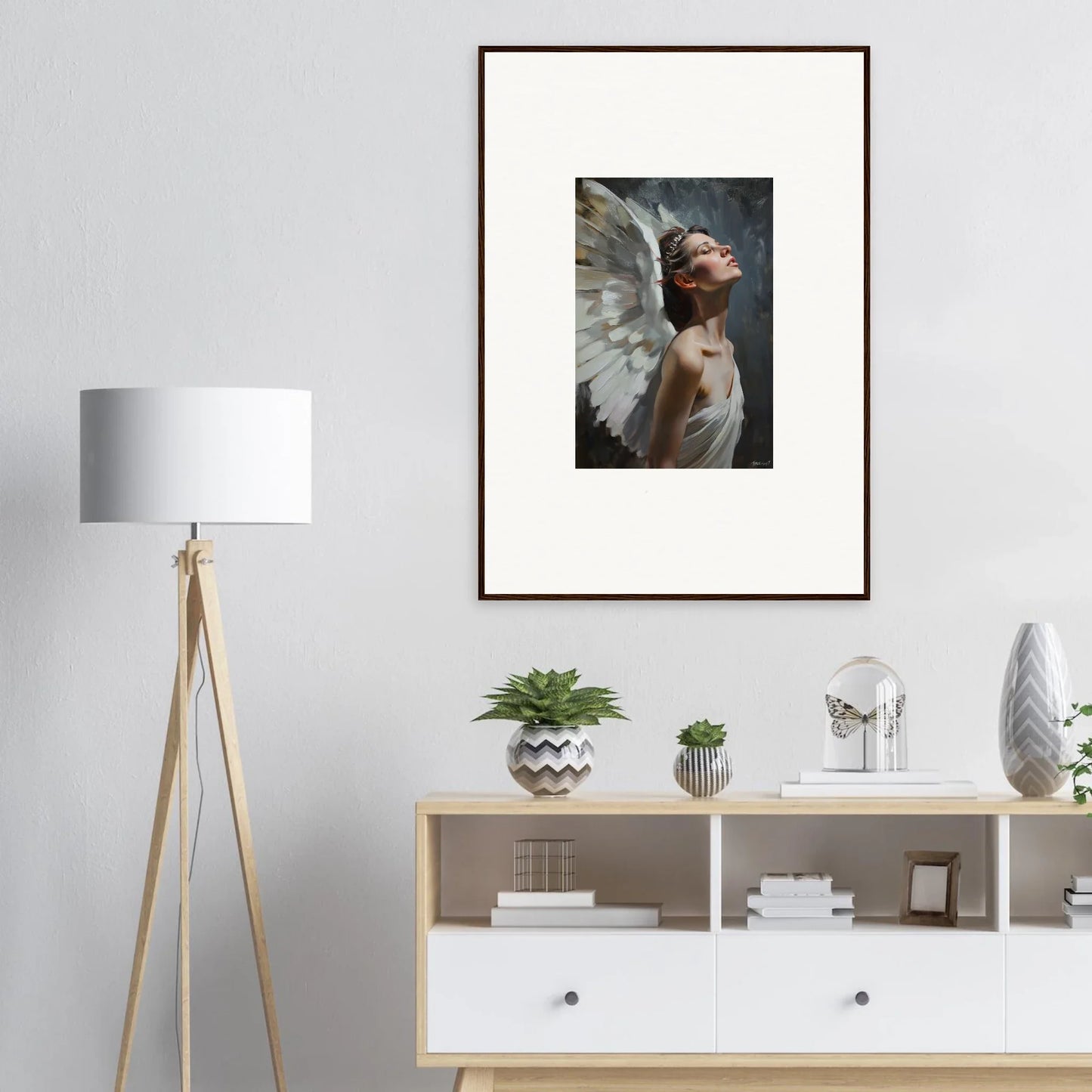 Framed wall art featuring a winged figure in dramatic pose, ideal for light orchard room decor