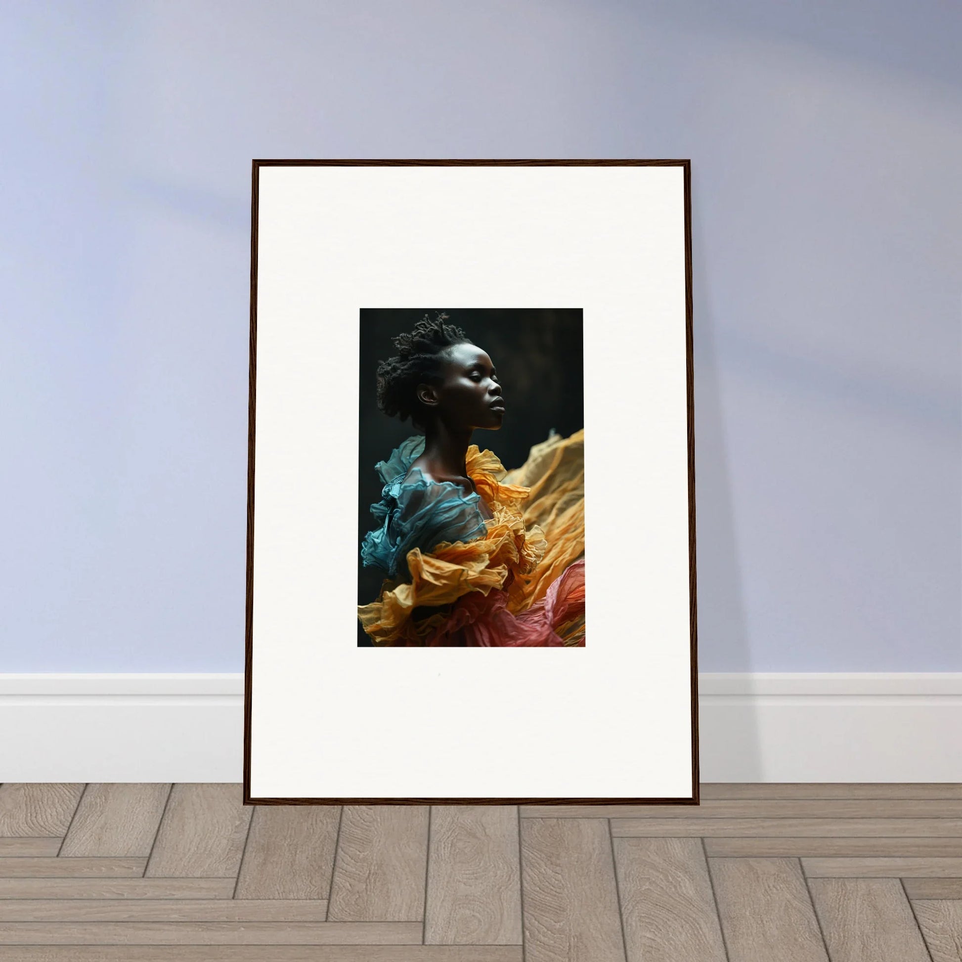 Framed portrait of a person surrounded by vibrant, flowing fabric in various colors.