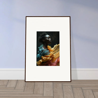 Framed portrait of a person surrounded by vibrant, flowing fabric in various colors.