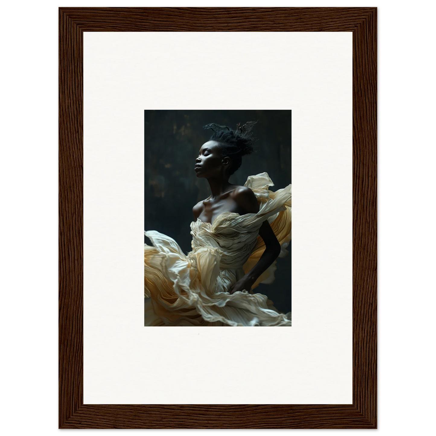 Framed portrait photograph of a person with dark skin wearing flowing white fabric.