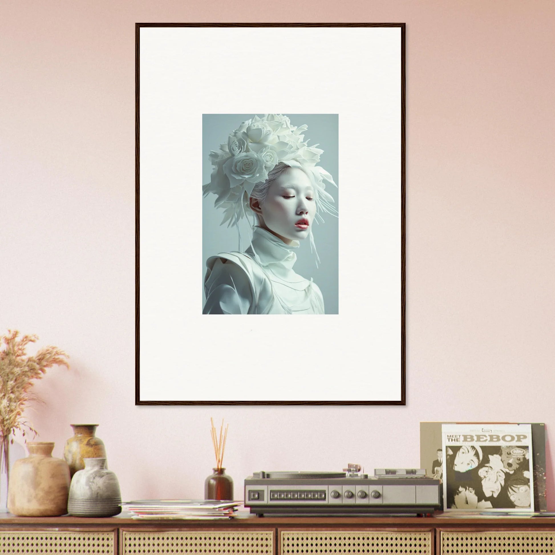 Framed wall art of a pale florid creature with an elaborate white headdress