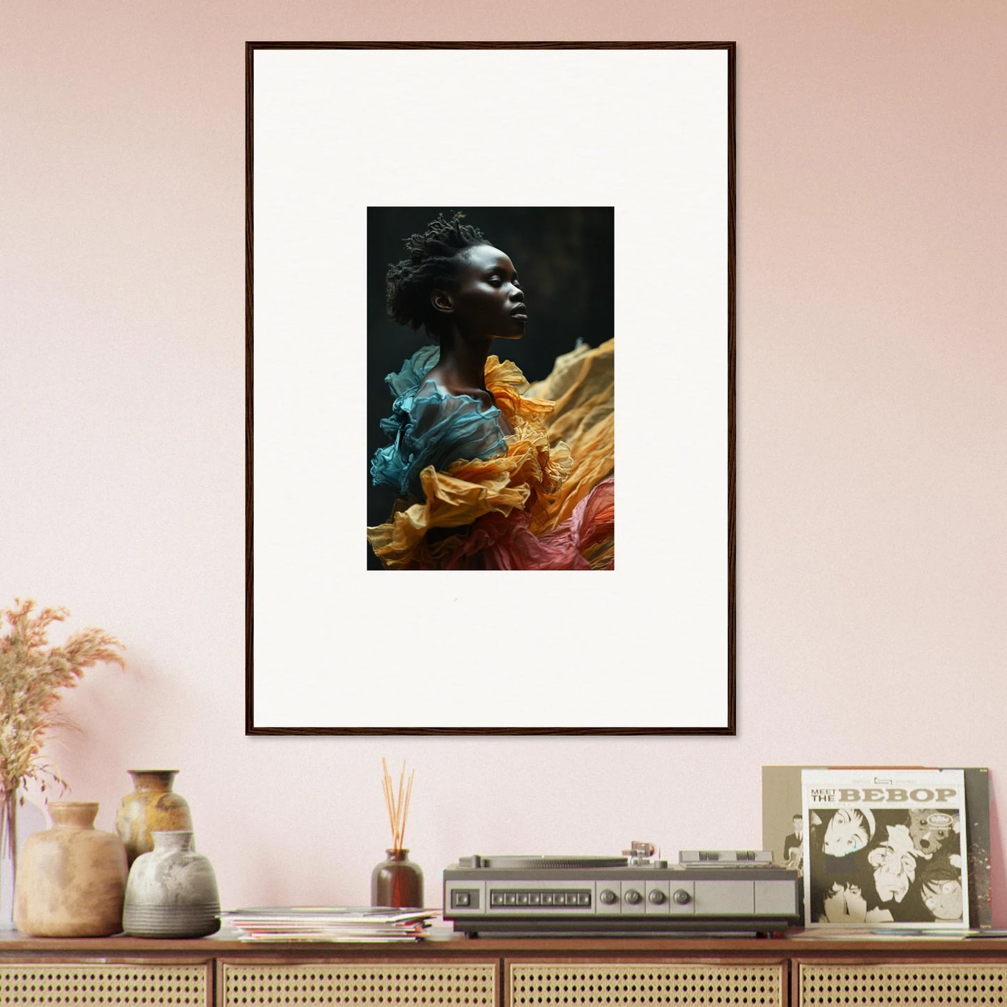 Framed portrait photograph featuring vibrant, flowing fabrics in blue, yellow, and pink hues.