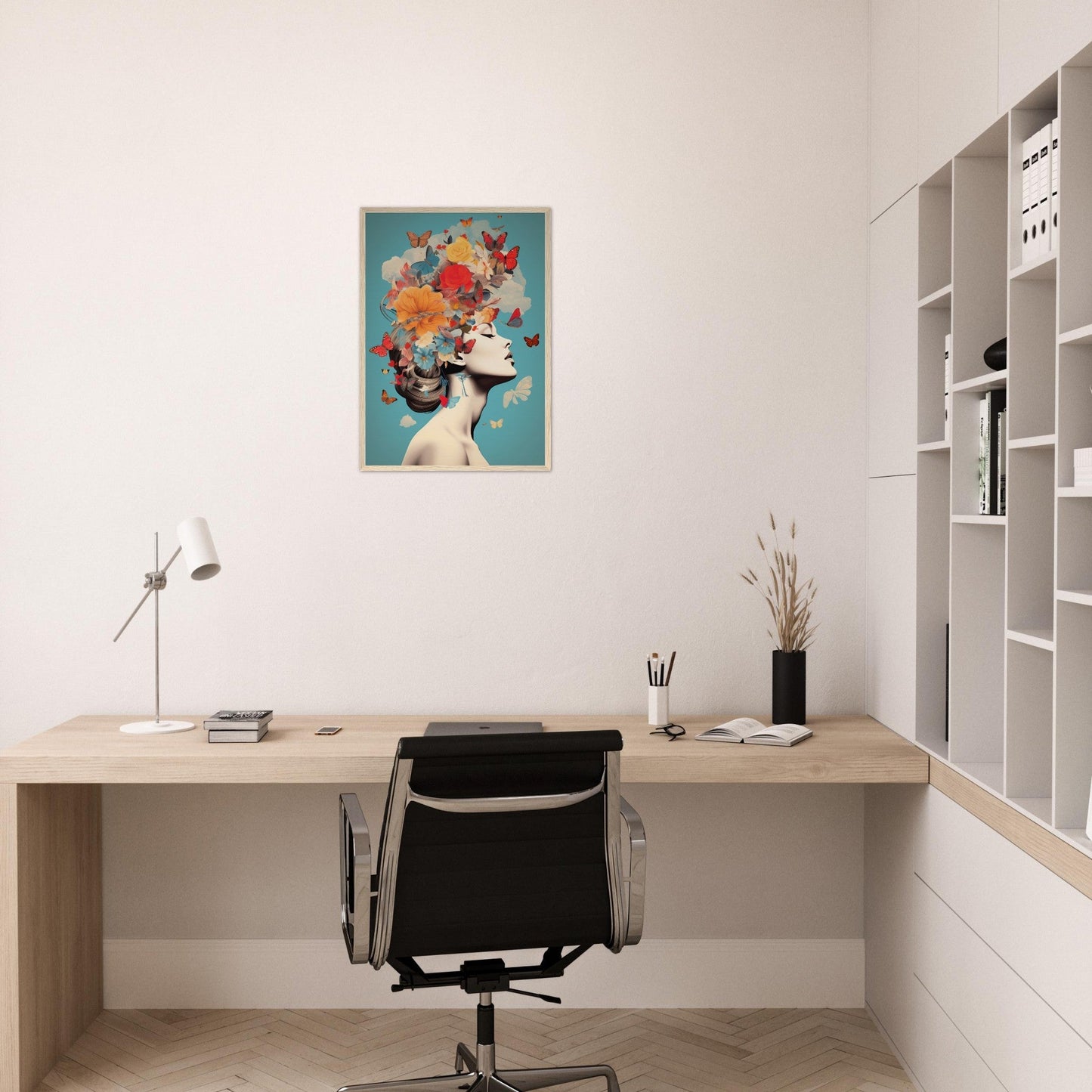 Minimalist home office workspace with a wooden desk, office chair, and colorful framed artwork on the wall.