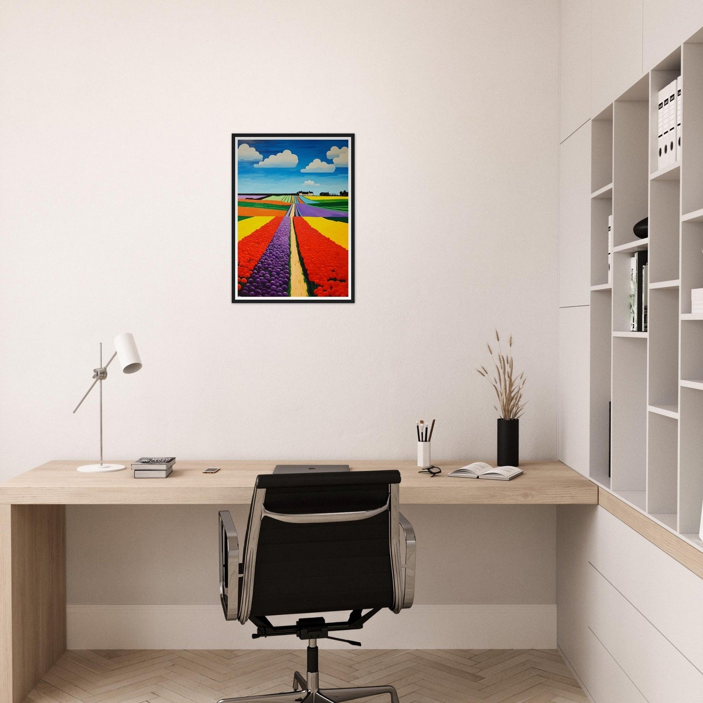 Minimalist home office workspace with a desk, chair, and colorful framed artwork.