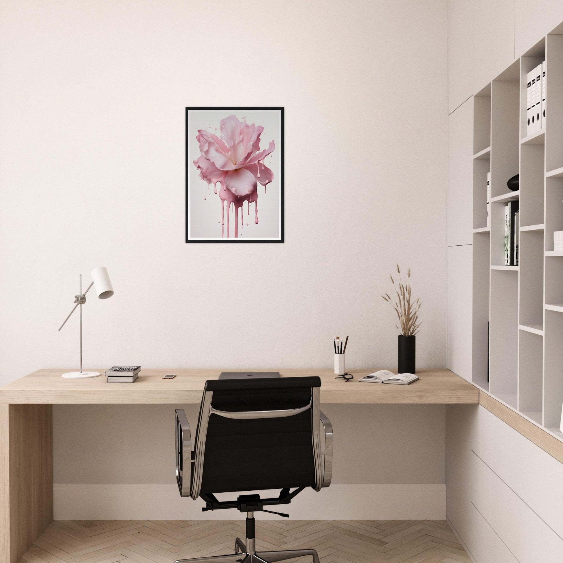 Minimalist home office workspace with a wooden desk, black office chair, and pink floral wall art.