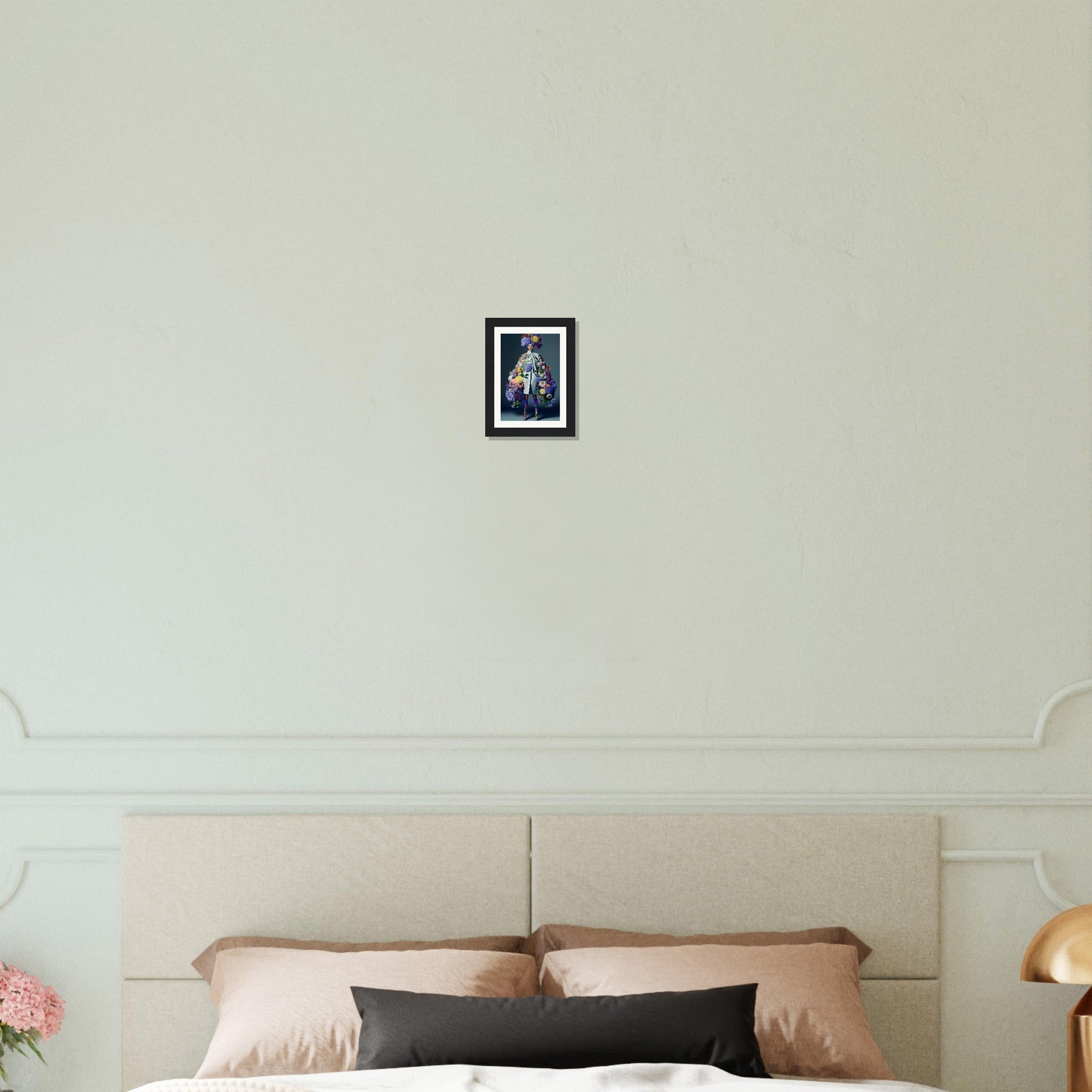 Framed photograph hanging on a white wall above a bed headboard.