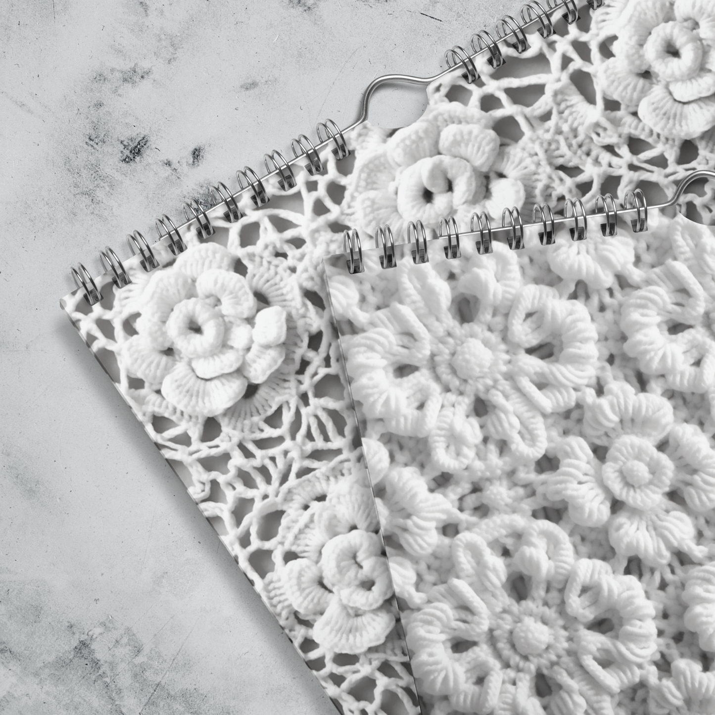 A Crochet Patterns Wall Calendar for 2024 on a marble surface, perfect for crochet enthusiasts.