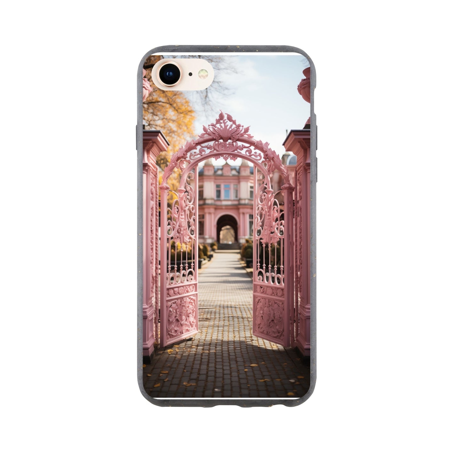 Ornate pink metal gate opening to a brick pathway leading towards a building.