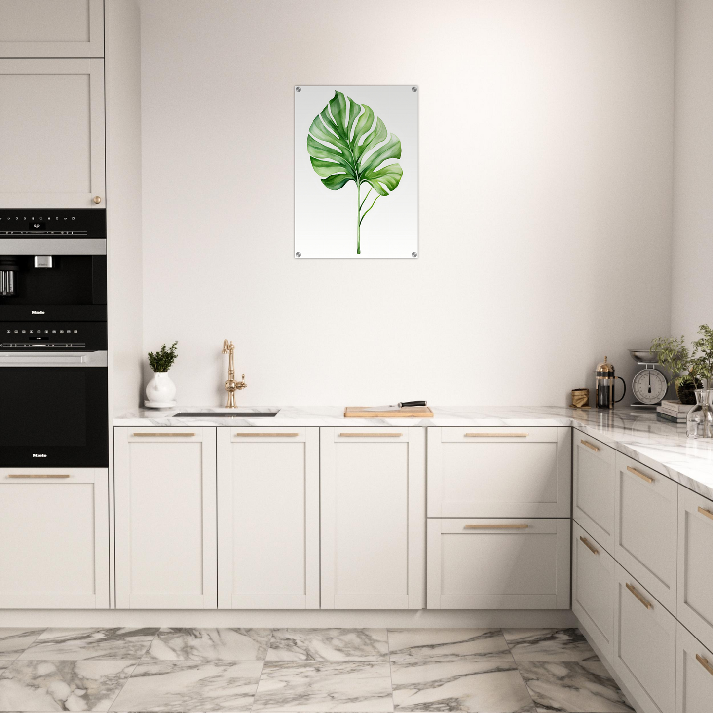 A kitchen with white cabinets and a large green leaf on the wall