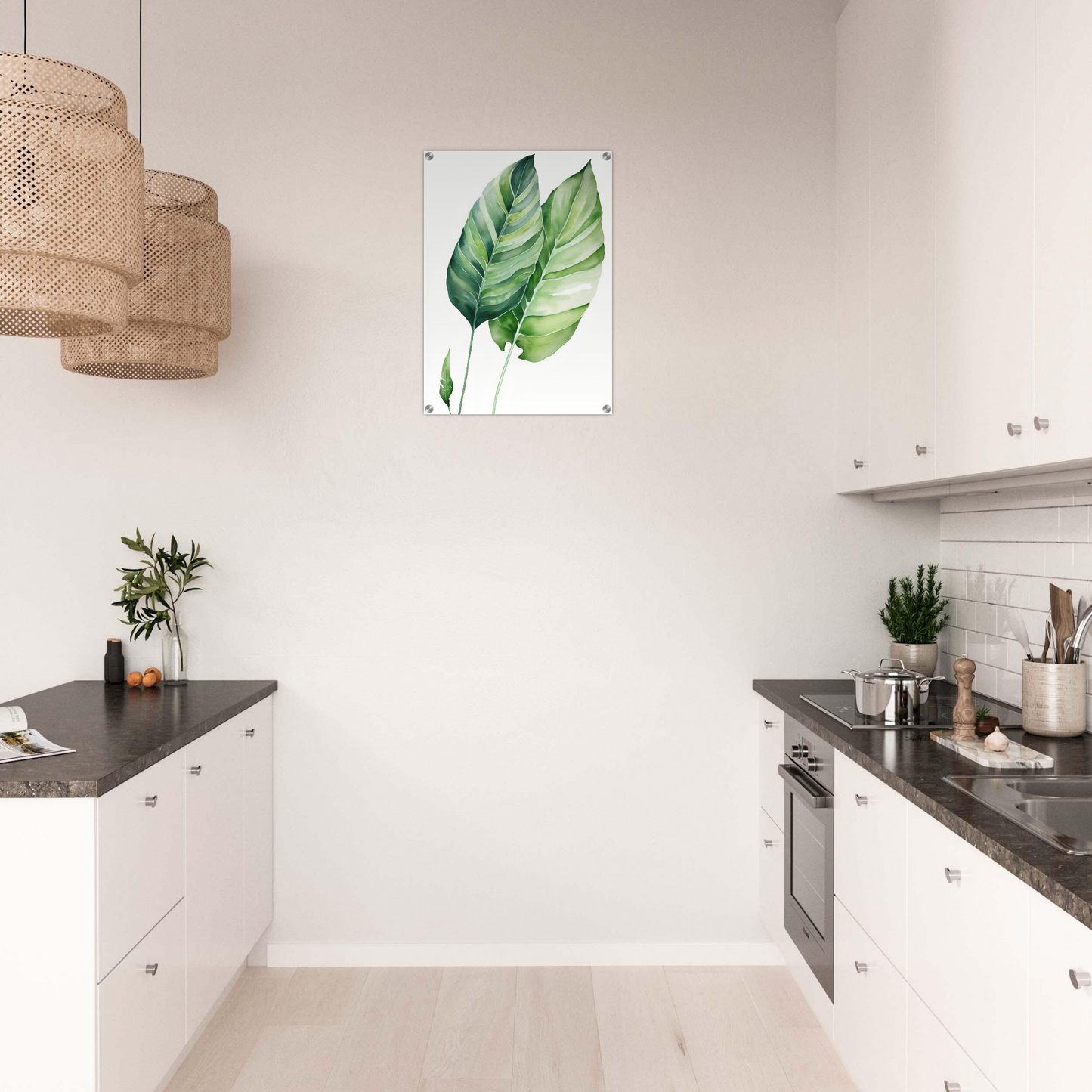 A kitchen with white cabinets and a large green leaf print on the wall