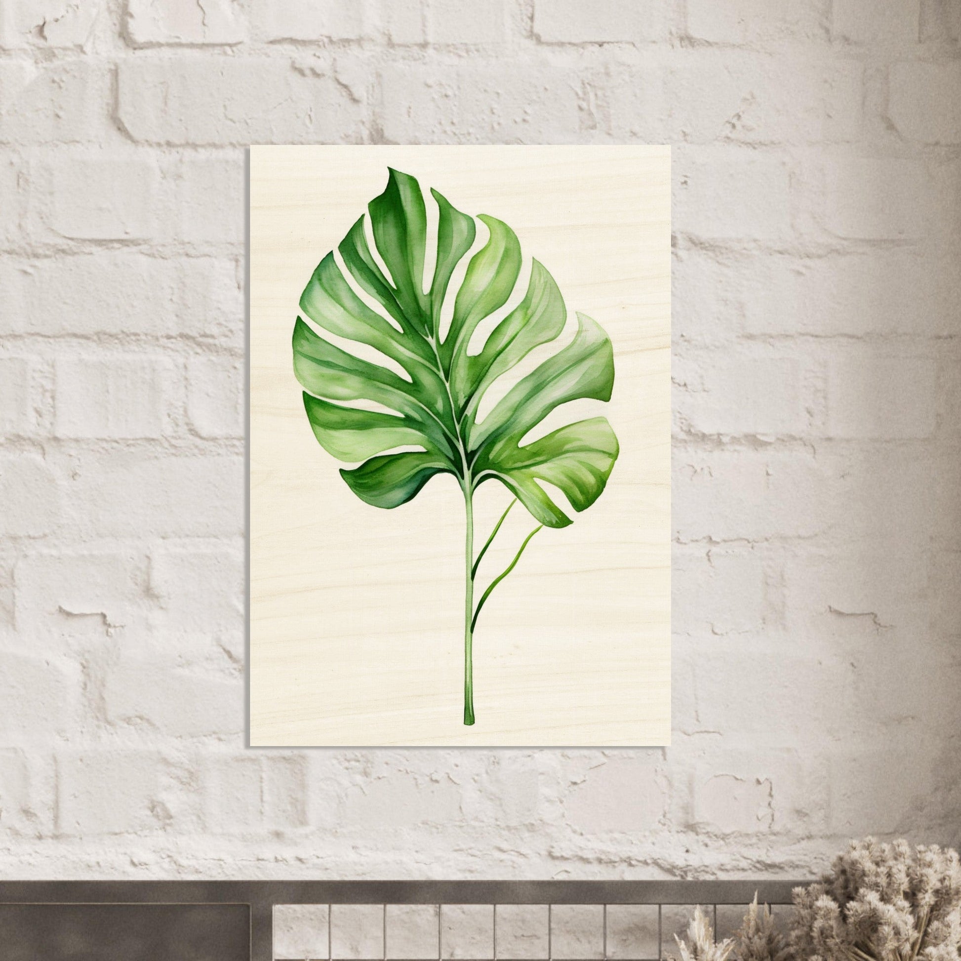 A large green leaf on a white brick wall