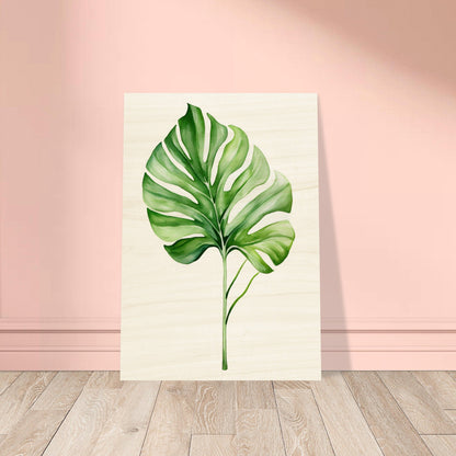 A large green leaf on a wooden floor