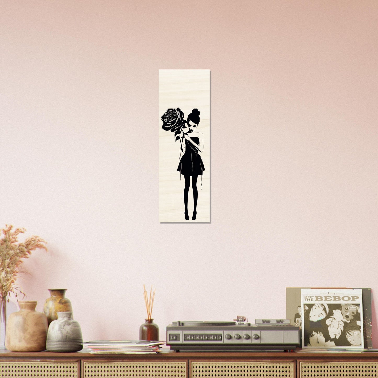 Silhouette artwork of a girl holding a rose, displayed on a canvas.