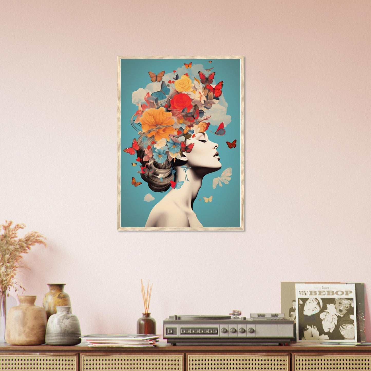 Framed artwork depicting a woman’s profile with colorful butterflies and flowers emerging from her head.