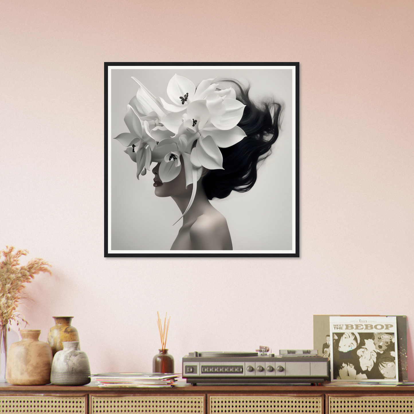 Framed black and white artwork depicting a silhouette with flowers as hair.