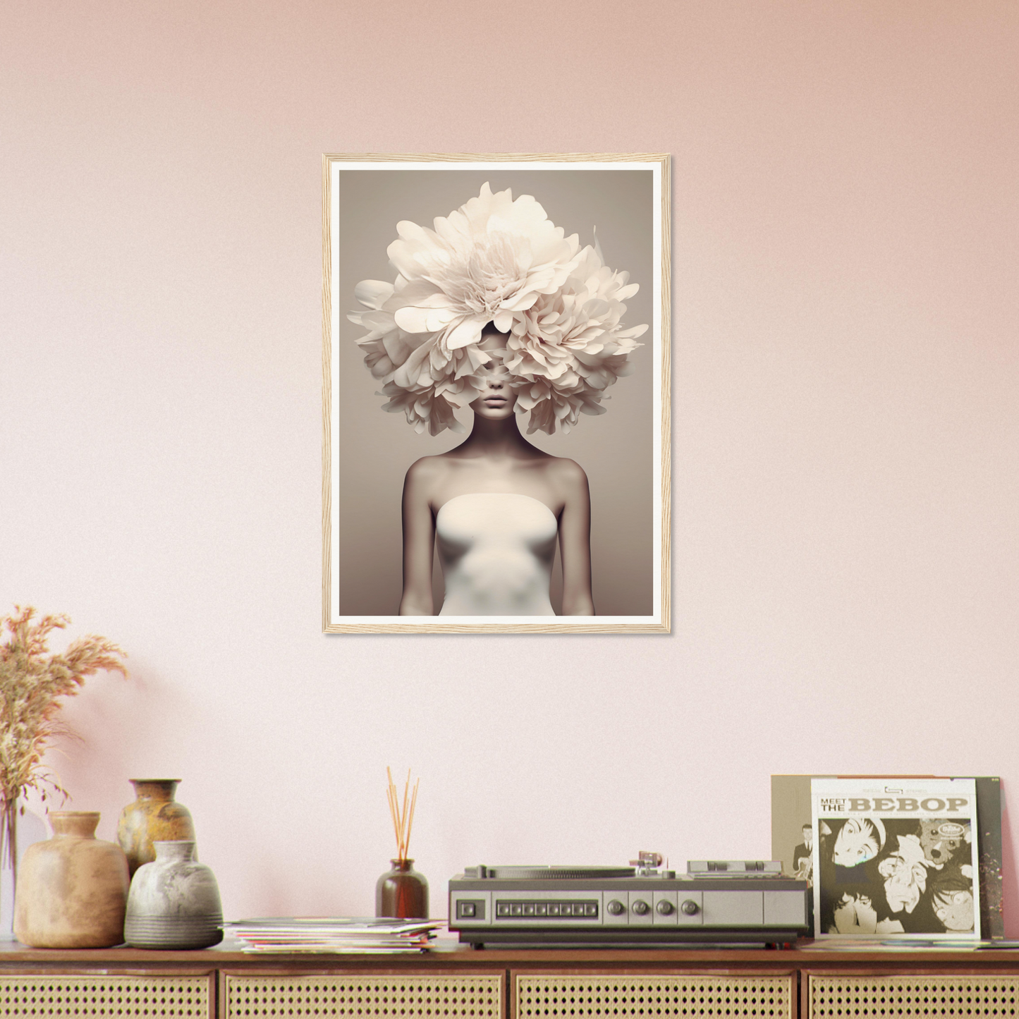 Framed black and white photograph of a figure with an elaborate floral headdress.