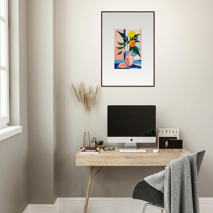 Minimalist home office with wooden desk, computer, and colorful framed wall art