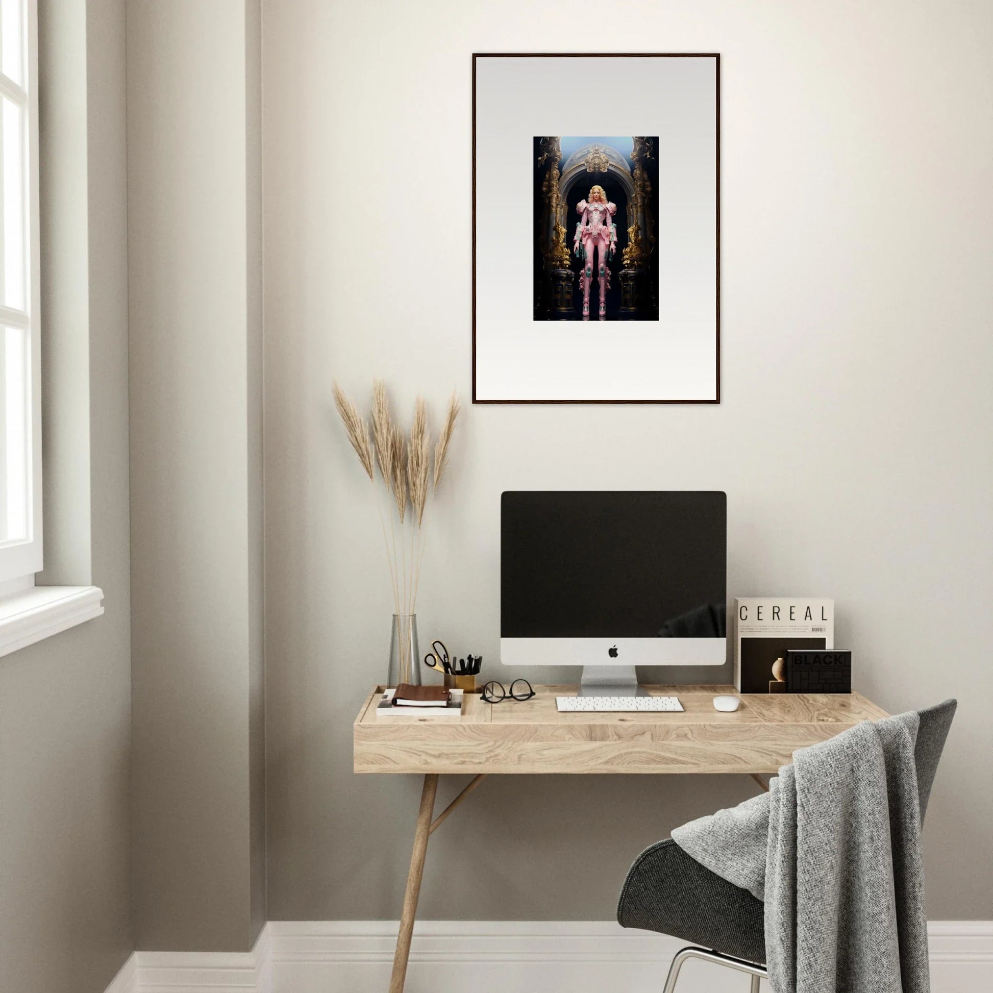 Minimalist home office with wooden desk, computer, and Pastry Vanguard framed wall art