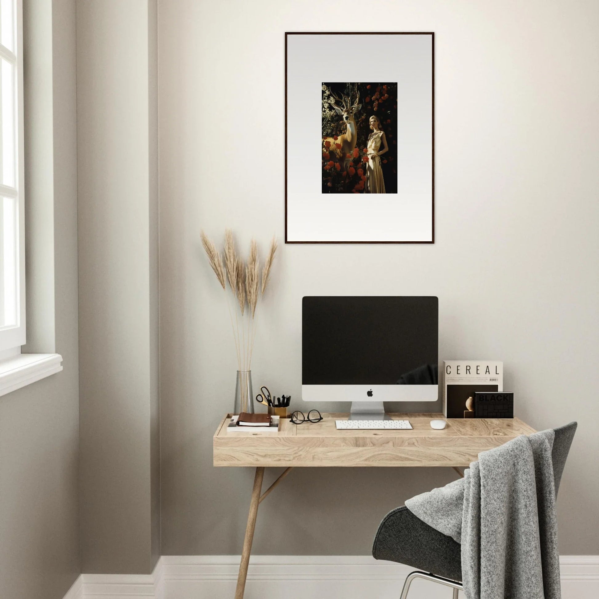 Minimalist wooden desk with a computer monitor and decorative accessories.