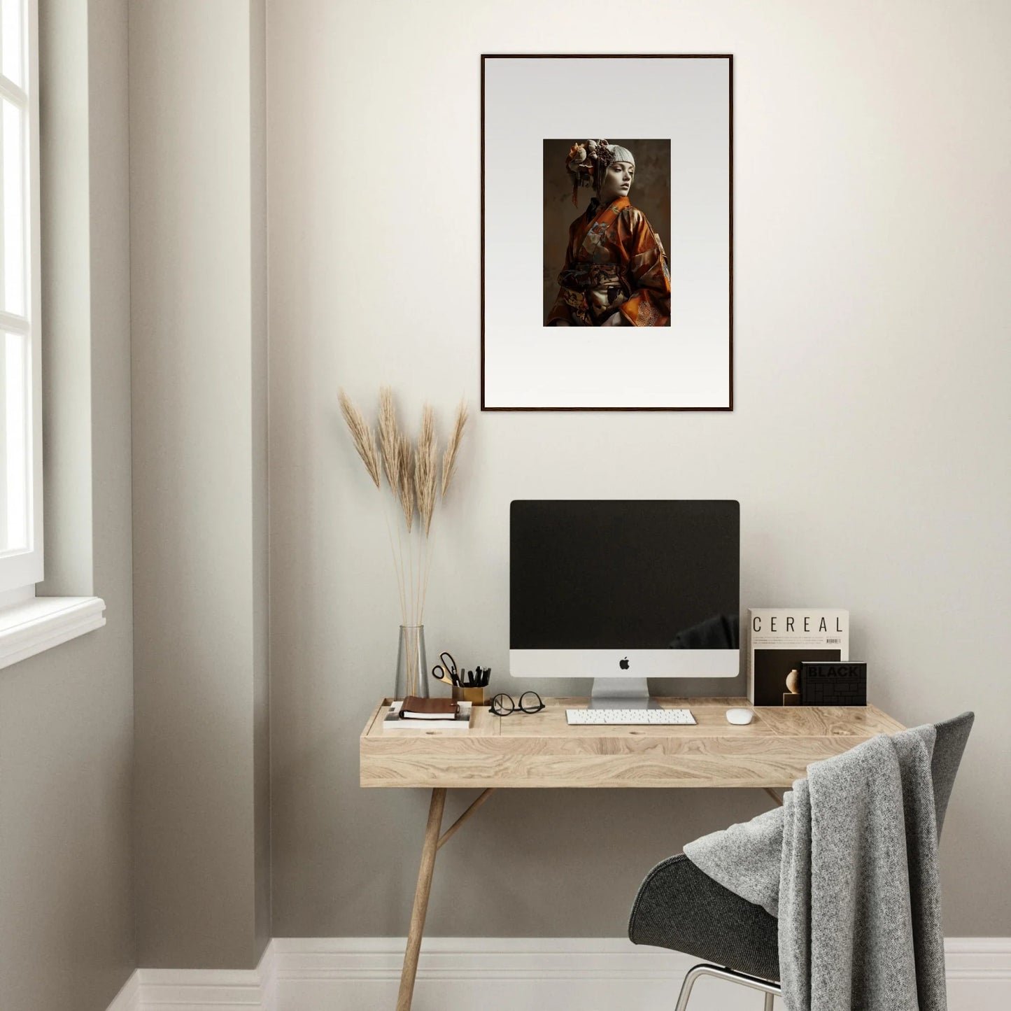 Minimalist wooden desk with computer monitor and framed wall art, shadows whispering decor